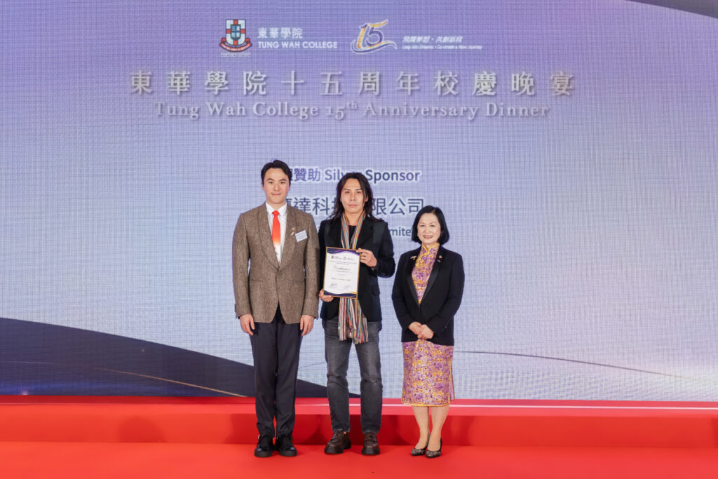 Our COO is receiving a Certificate of appreciation on stage from Tung Wah College.